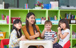 © weedezign - Asian female teacher and mixed race kids thumbs up in classroom,Kindergarten pre school concept.