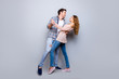 Full body portrait of creative cheerful couple in casual outfits dancing enjoying activity isolated on grey background. Move motion life art concept