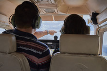 Two Pilots Sitting In A Cockpit Of Cessna Skyhawk 172 Airplane.