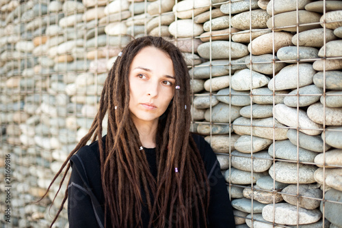 Portrait Of A Beautiful Lonely Girl With Dreadlocks Looking