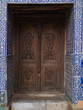 © ADDICTIVE STOCK - Ornamental carved door in tiled oriental wall
