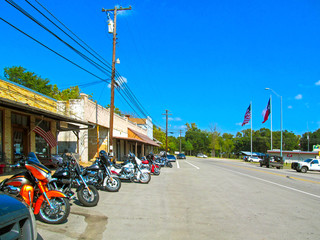 Parking motorcycles in a row along the street.
Motorbikes of bikers parked at the usual meeting place near Canton in Texas on a sunny day during a weekend trip. 