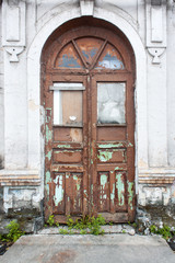 Wall Mural - Old ancient painted door with stairs against  background