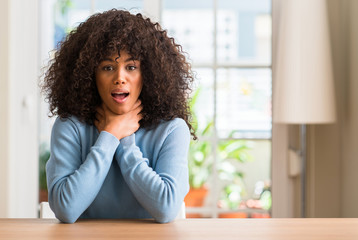 Poster - African american woman at home shouting and suffocate because painful strangle. Health problem. Asphyxiate and suicide concept.