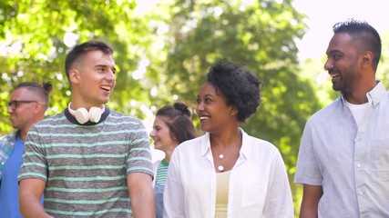 Poster - people, friendship and international concept - group of happy friends walking in park