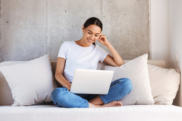 Wall Mural - Attractive young asian woman using laptop computer