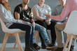 © Photographee.eu - Group of young people sitting in a circle and talking to psychiatrist  during a therapy