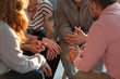 © Photographee.eu - Close-up of a support group and their hands during a therapy