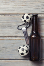 Beer Bottle With Soccer Football Balls On A Wooden Background