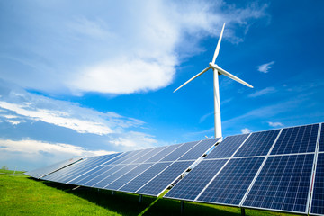 Wall Mural - solar energy panels and windmills against blue sky on summer day