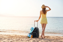 Beautiful Young Woman With A Hat Standing With Suitcase On The Wonderful Sea Background, Concept Of Time To Travel