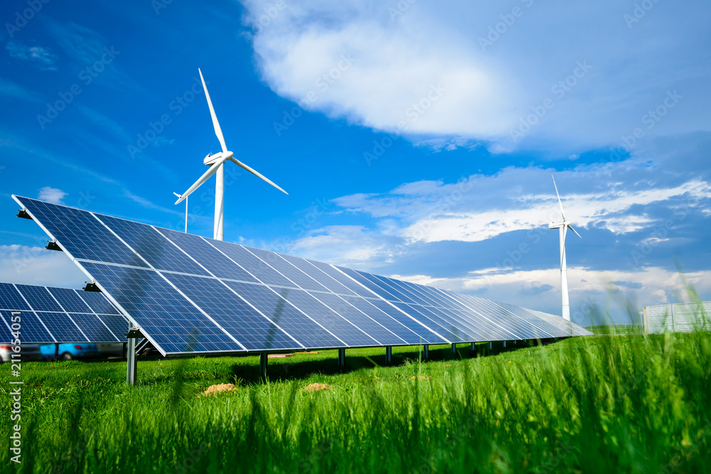 Solar energy panels and windmills against blue sky on summer day - obrazy, fototapety, plakaty 
