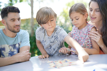 Wall Mural - Happy family enjoying playing game together