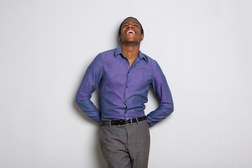 Wall Mural - cheerful young african businessman laughing and looking up