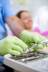 Dentist check up and repair tooth of young girl