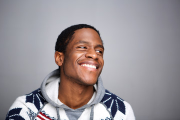 Wall Mural - young african american man laughing against gray background