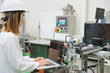 © naruecha - Woman software engineers developing automated robotic in production line, Industry