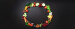 © jchizhe - Healthy food background. Circle of organic vegetables, fruits, nuts, berries with copy space on black chalkboard. Top view. Vegetarian, vegan, detox and clean eating concept