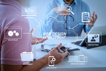Businessmen working together on a document and using smart phone and digital tablet and laptop computer in modern office