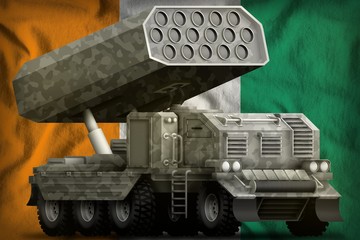 rocket artillery, missile launcher with grey camouflage on the Cote d Ivoire national flag background. 3d Illustration