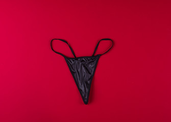 Wall Mural - black sexy black underwear on a red background