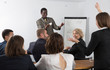© JackF - African American business coach communicating with auditorium