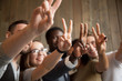 © fizkes - Close up of smiling multiracial people showing V sign making group picture, spending time, having fun together, happy diverse students gesturing victory or peace symbol demonstrating racial equality