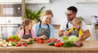 appy family with child  preparing vegetable salad