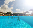 © bluebeat76 - Young woman swimming undewater in the swimming pool