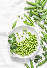 Fresh Green Peas On A Light Background, Top View. Flat Lay, Copy Space