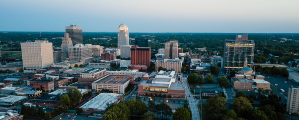 aerial view as night falls on the downtown city skyline at winston-salem