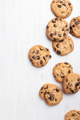 Wall Mural - American cookies with chocolate chips on white wooden background. Top view.