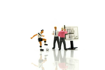 Miniature people : Soccer Football Coaches are Planning with the Players in the Tournament.