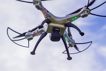 flying drone with remote control against blue sky background.