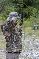 Wall Mural - A Man Shooting a Compound Bow at a Target.