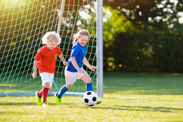 Sticker - Kids play football. Child at soccer field.