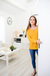 © W PRODUCTION - cheerful young woman welcome friends at open front door new student home apartment