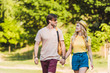 © LIGHTFIELD STUDIOS - portrait of happy couple in love walking in summer park together