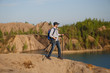 © snedorez - Image of tourist man in cap with walking sticks on mountain hill