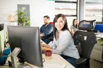Beautiful woman working at her office desk