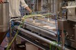 © Wavebreak Media - Mid section of worker standing near food production line