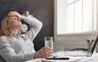 © Prostock-studio - Tired financial adviser with headache at office