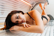 © mnelen.com - attractive slender brunette girl lies in a horizontal solarium, wants a beautiful tanned skin