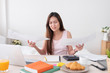 © weedezign - Asian woman freelancer upset with work problem with laptop on mess table.work at home concept.stress working.