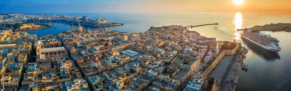 Valletta, Malta - Aerial panoramic view of Valletta with Mount Carmel church, St.Paul's and St.John's Cathedral, Manoel Island, Fort Manoel, Sliema and cruise ship entering Grand Harbor at sunrise - obrazy, fototapety, plakaty 