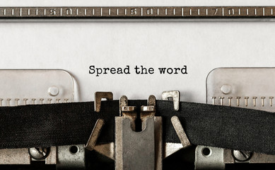 Wall Mural - text spread the word typed on retro typewriter