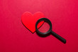 Red heart and magnifier. Looking for love cocept