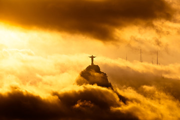 Fototapete - Corcovado Mountain with Christ the Redeemer Statue in Clouds on Sunset in Rio de Janeiro, Brazil