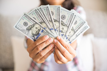 woman hands holding us dollar bills.