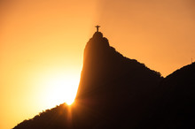 The Famous Rio De Janeiro Landmark - Christ The Redeemer Statue On Corcovado Mountain. Silhouette By Sunset